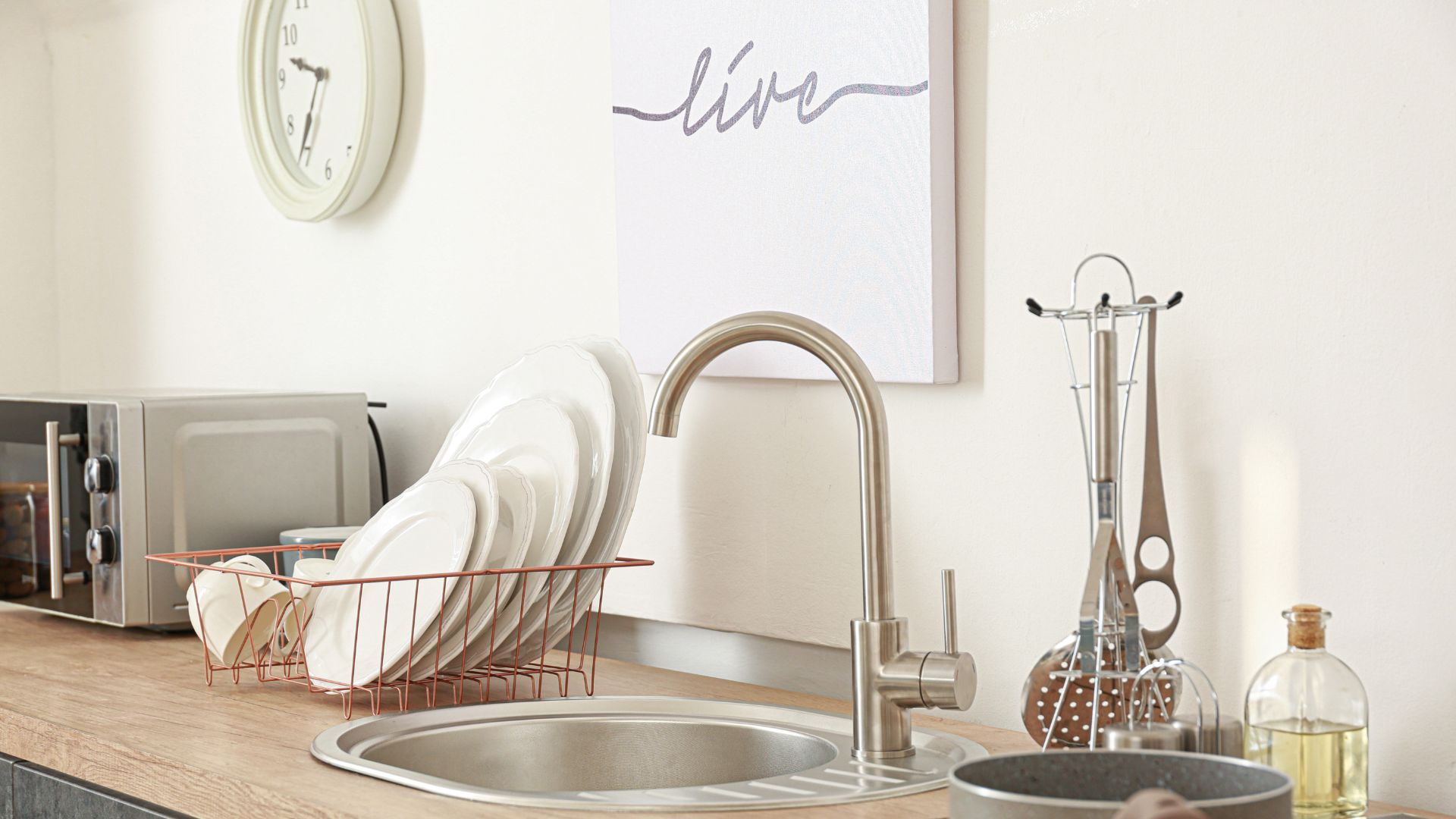 A kitchen counter with dishes and a microwave