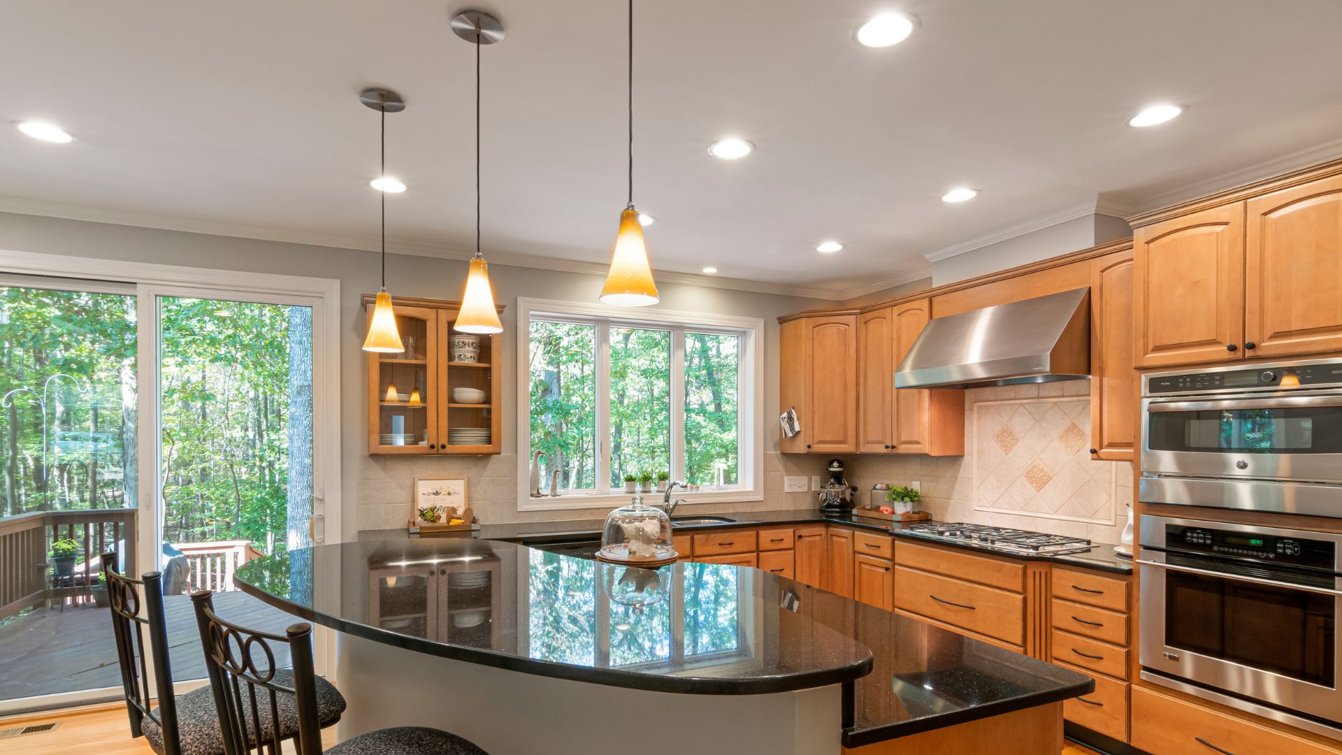 A kitchen with a center island and a stove top oven